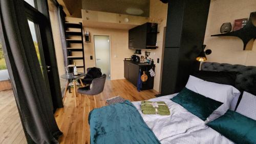 a room with a bed and a living room at Pöögle Järvemaja in Pöögle