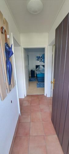 a hallway with a door leading to a bedroom at Schmuckkästchen Bungalow 50 in Dipperz