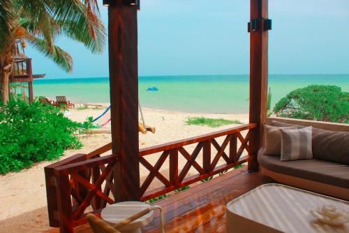 a living room with a view of the beach at Esciros in Chicxulub