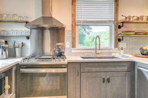 a kitchen with stainless steel appliances and a window at Historic Charm and Modern Luxury 6 Mi to Stowe Mtn in Stowe