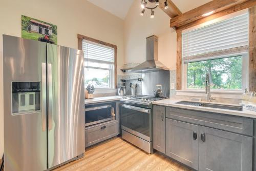 a large kitchen with a stainless steel refrigerator at Historic Charm and Modern Luxury 6 Mi to Stowe Mtn in Stowe