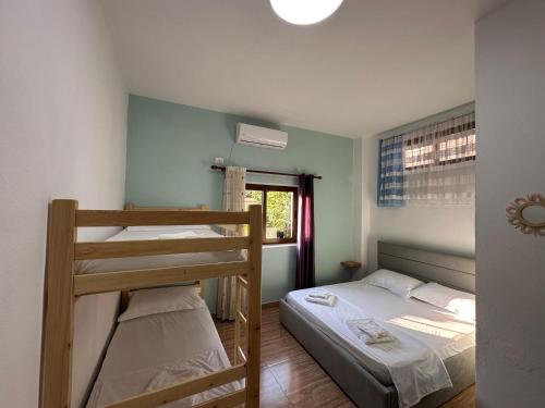 a bedroom with two bunk beds and a window at Las Palmas Guesthouse in Shkodër
