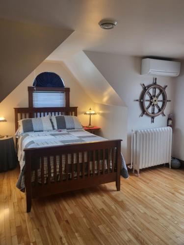 a bedroom with a bed in a attic at Cranberry Cove Inn in Louisbourg