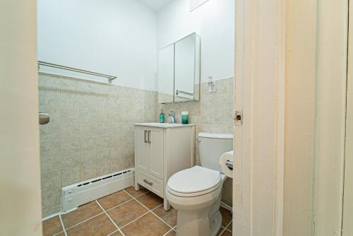a bathroom with a white toilet and a shower at Cozy Double Private Room, Comfy Bed, Free Parking in Toronto