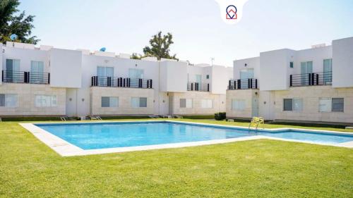 a swimming pool in front of a large building at Modern house in Yautepec in Yautepec
