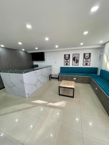 a waiting room with a bench and a table at Hotel Embajada 44 in Bogotá