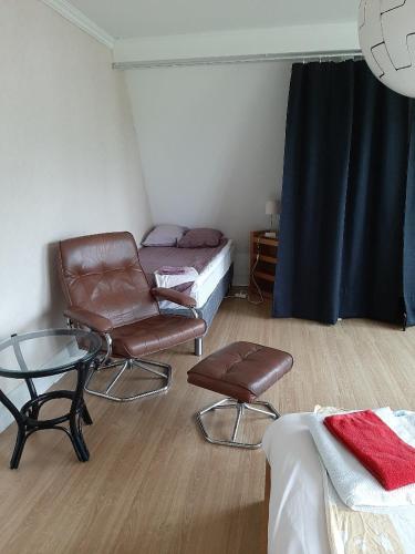 a room with a bed and a chair and a table at Semester Hem 2 Storvik in Storvik