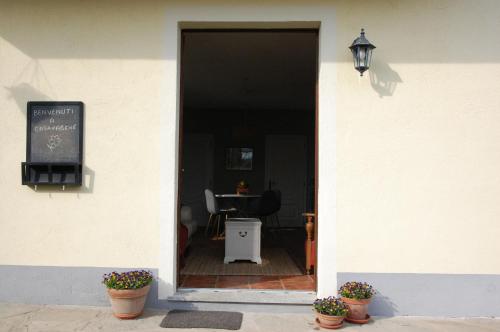 a entrance to a restaurant with potted plants in the doorway at Casavabene in Murazzano