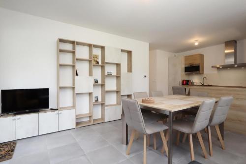 a kitchen and dining room with a wooden table and chairs at Résidence Hameau Des Reines - Hameau des Reines MAE-9981 in Servoz