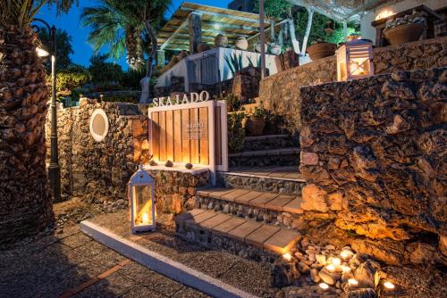 a set of stone stairs with lights on them at Skajado Holiday Apartments in Stalida