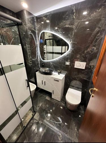 a bathroom with a toilet and a sink and a mirror at Venice Rainbow Apartments BIENNALE in Venice