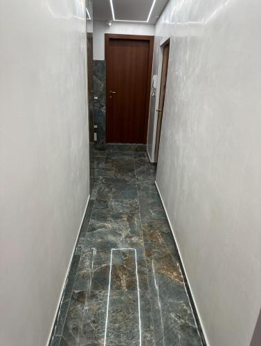 an empty hallway with a door and a tile floor at Venice Rainbow Apartments BIENNALE in Venice