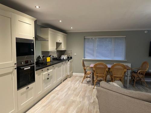 a kitchen with a table and chairs and a couch at The Apartment at Woodside in Stockton-on-Tees