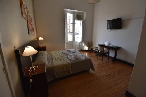 Postel nebo postele na pokoji v ubytování Hotel Plaza