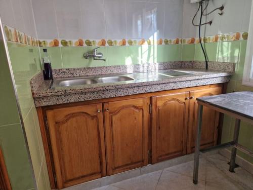 a kitchen with a sink and a counter top at Logement climatisé proche de Fès in El Harmiine