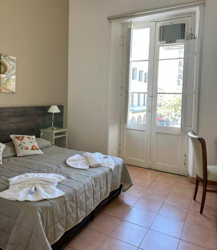 Postel nebo postele na pokoji v ubytování Hotel Plaza