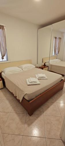 a bedroom with a bed with two towels on it at Casa Francesca: un mare di relax! in Ventimiglia