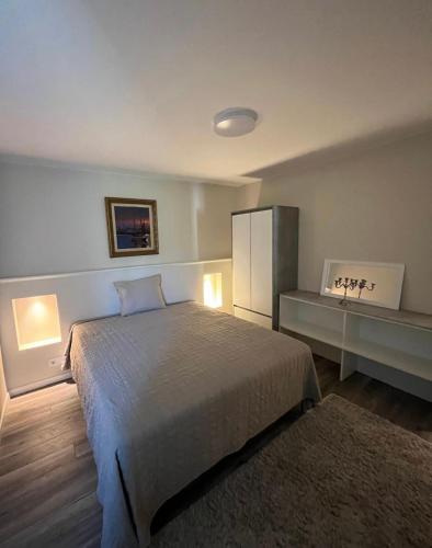 a bedroom with a bed and a cabinet and a rug at Köpingebro in Köpingebro