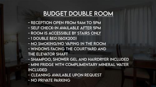 a black and white sign with white writing on a wall at OPERA16 Guestrooms in Budapest