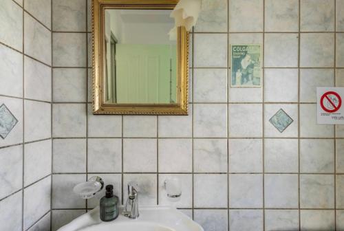 a bathroom with a sink and a mirror at Villa Lefka Stunning Seaside Villa in Corfu with Private Gardens in Melíkia