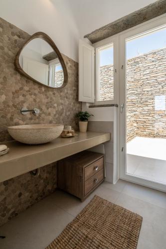 a bathroom with a sink and a mirror and a window at Gaia & Thalassa Villa Orionas in Otziás