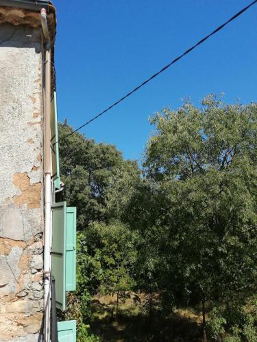 a view of trees from the side of a building at Mas Ferrieres Saint Laurent sud in Saint-Laurent-le-Minier