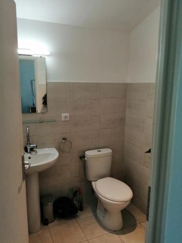 a bathroom with a toilet and a sink at Mas Ferrieres Saint Laurent sud in Saint-Laurent-le-Minier
