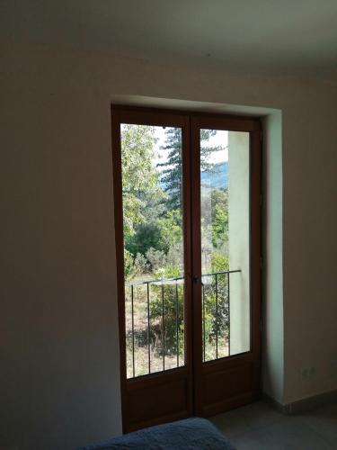 a room with a sliding glass door with a view at Mas Ferrieres Saint Laurent sud in Saint-Laurent-le-Minier