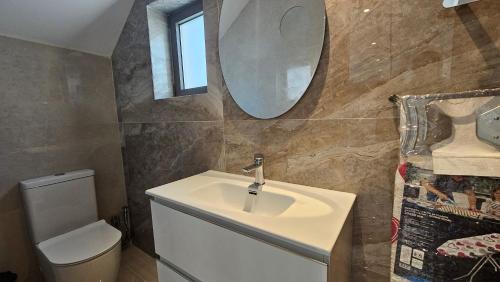 a bathroom with a sink and a toilet and a mirror at STAY Oasis Luxury Villas in Ayia Napa