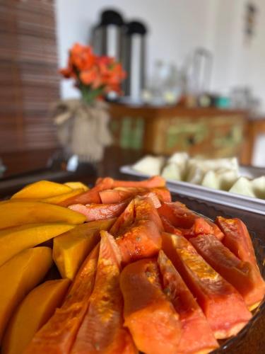 a pile of food on a tray next to bananas at Mar à Vista Ilha de Boipeba in Ilha de Boipeba