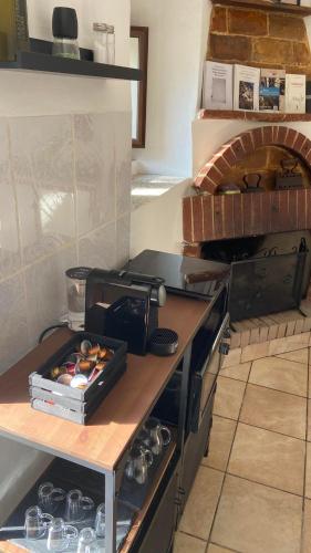 a kitchen with a counter top with a pizza oven at B&B La Majella Me in Abbateggio