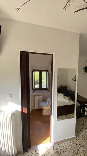 a room with a bathroom with a bed and a toilet at B&B La Majella Me in Abbateggio