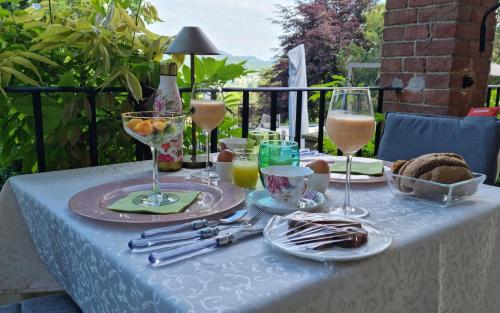 a table with wine glasses and food on it at Villa Giordana in Casalborgone
