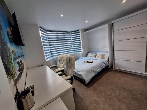 a small bedroom with a bed and a window at Sunny Waves in Northampton