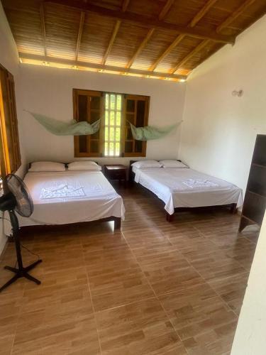 a room with two beds in a room at cabañas Brisas del mar el valle in Bahía Solano