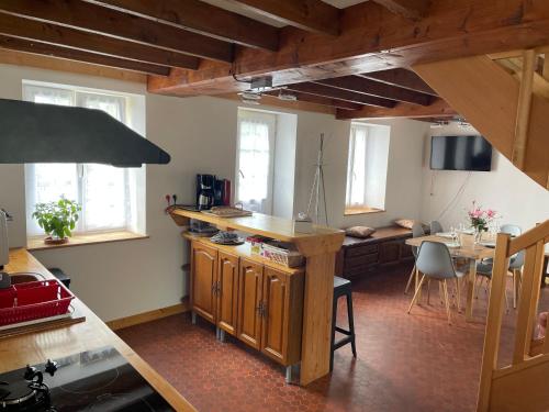une cuisine avec une table et une salle à manger dans l'établissement Gîte du Cerisier, à Liesville-sur-Douve