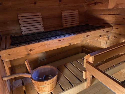 an inside view of a sauna with a bucket at Lapland Chalet Lomalaavu in Suomutunturi