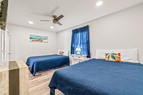 a bedroom with two beds and a ceiling fan at Moonraker 25 in Gulf Shores