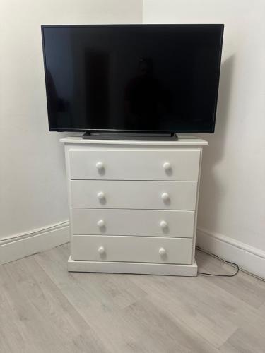a tv on top of a dresser with a tv on it at Independent en-suite bedrooms in Southampton
