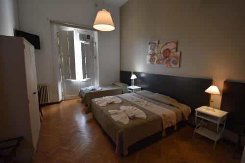 Postel nebo postele na pokoji v ubytování Hotel Plaza