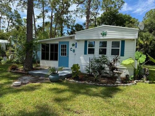 a small white house with a blue door at Venice Bungalow in Venice
