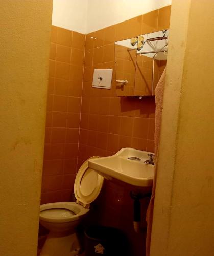a bathroom with a toilet and a sink at Casa Marconi in Posadas