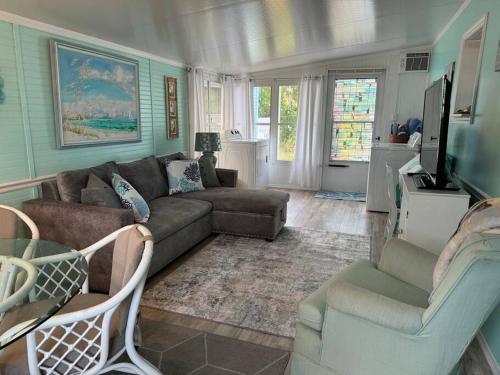 a living room with a couch and two chairs at Venice Bungalow in Venice