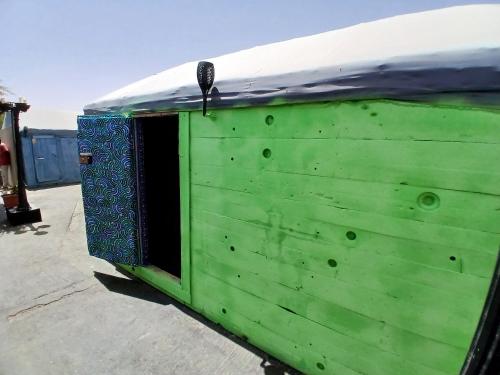 a green building with a snow covered roof at "Par 4 Chemins" - Atypical stopover in Nouakchott