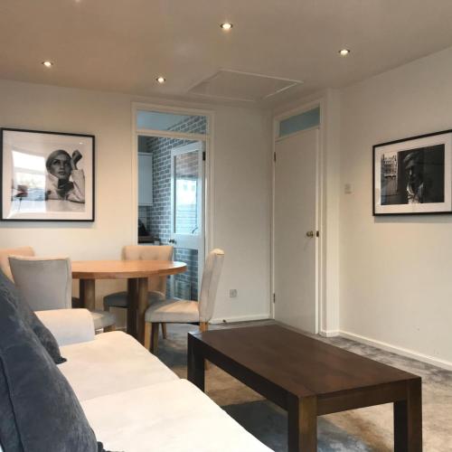 a living room with a couch and a table at Tourist board certified Super city centre apartment with free parking in Belfast