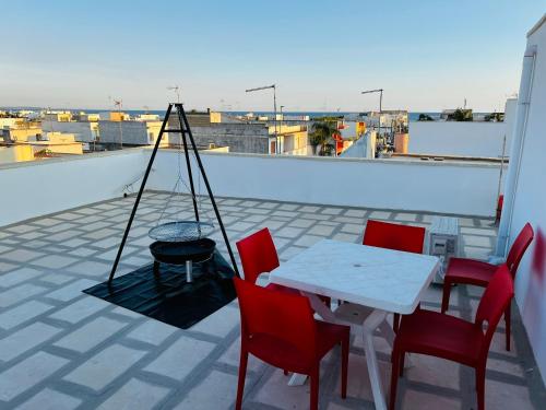 トッレ・ラピッロにあるCasa Idoneの屋根の上にテーブルと椅子