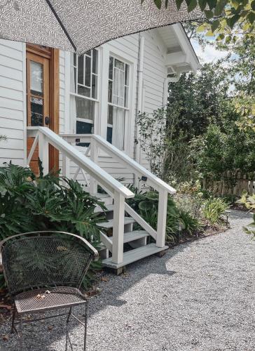 a white staircase leading to a porch of a house at Guesthouse on Girod in Mandeville