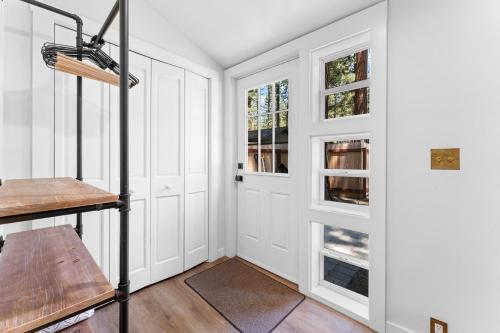 a room with white walls and a door with windows at Troubadour's Landing in Kings Beach