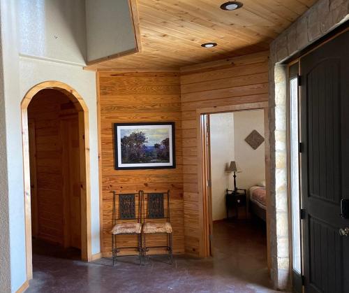 a room with a chair and a painting on the wall at Mountain Laurel Lodge in Concan
