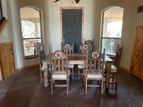 a dining room with a wooden table and chairs at Mountain Laurel Lodge in Concan